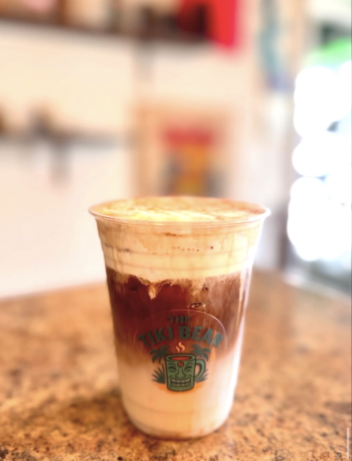 Layered iced Tiki Bean coffee in a branded cup